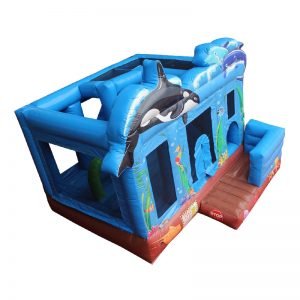Birds eye view of a blue inflatable bouncy castle with Orca whale and two dolphins.